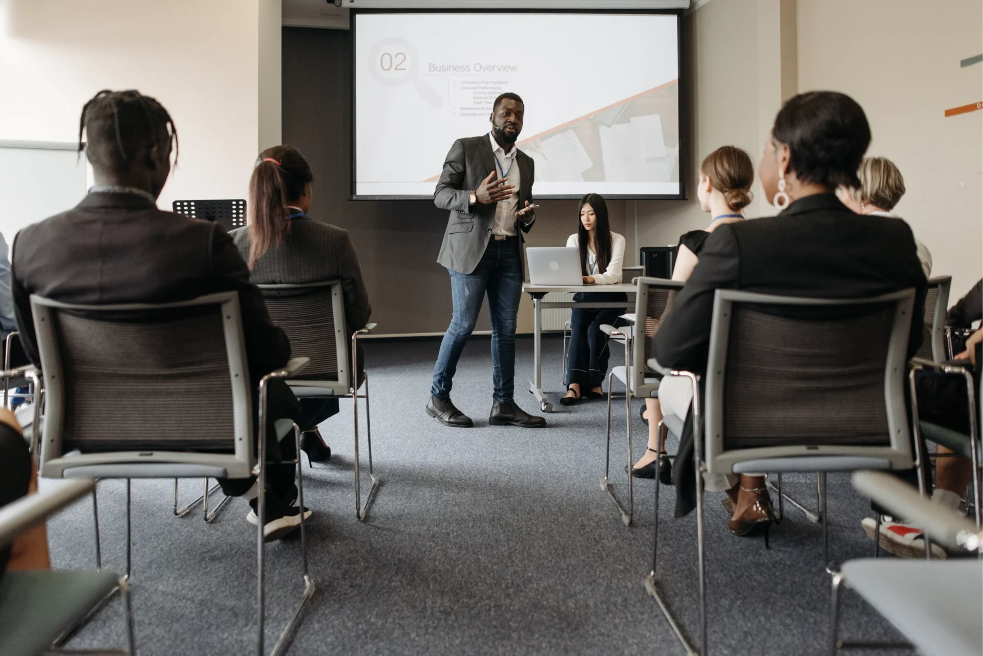 A speaker presenting in front of employees in a training session