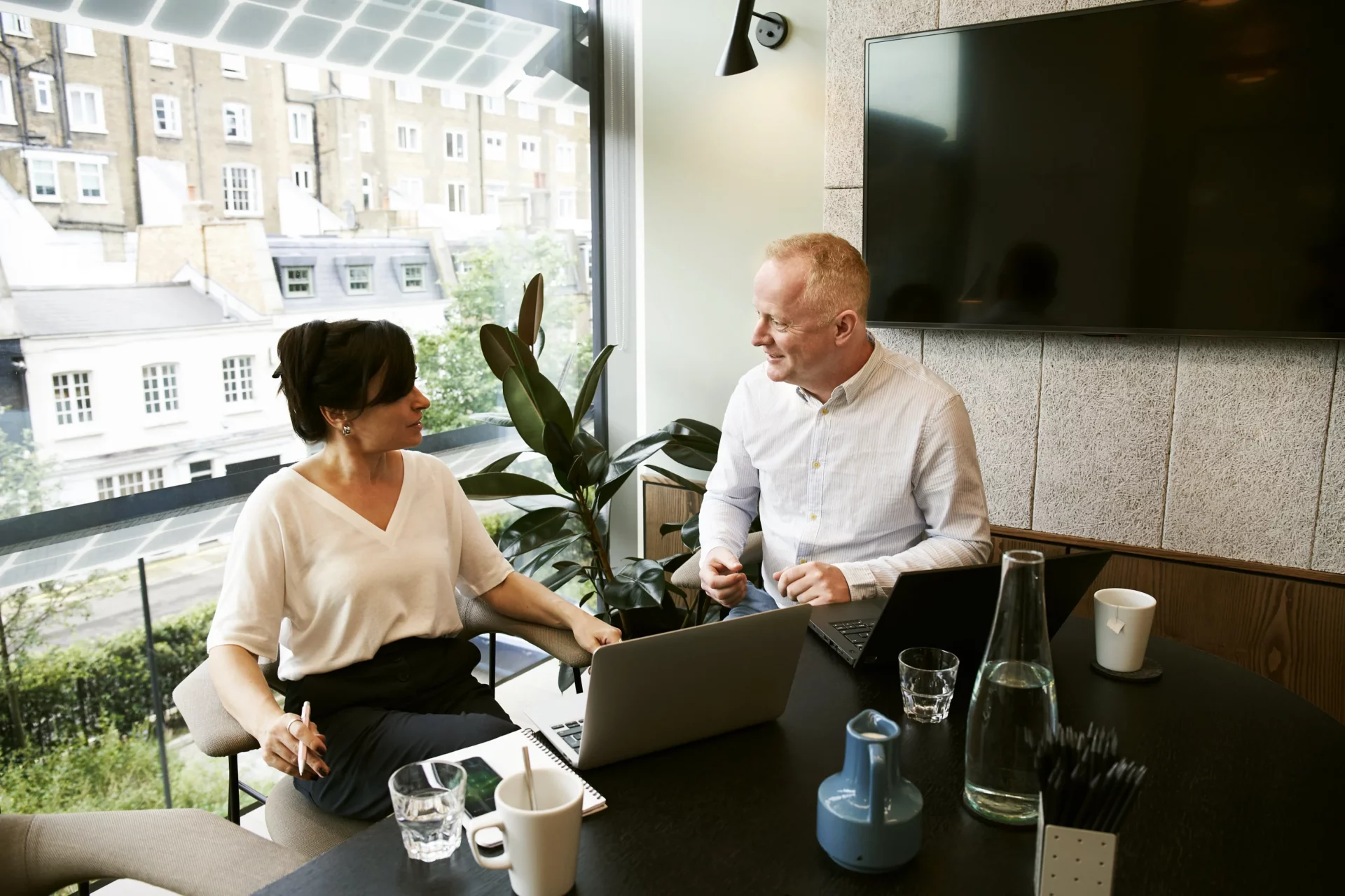 Two professionals sitting in a conference room in a coaching session